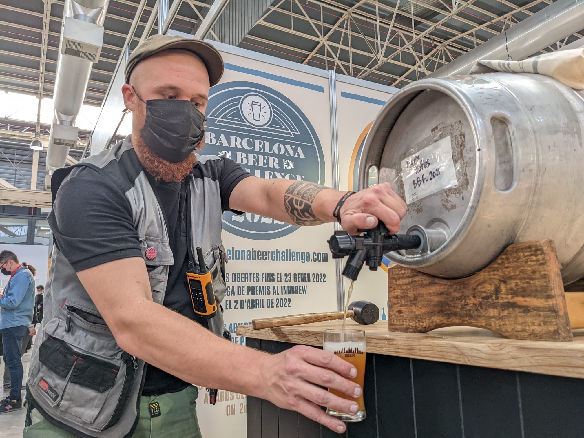 A brewer pours a beer at the 2021 Barcelona Beer Festival (by Cillian Shields)